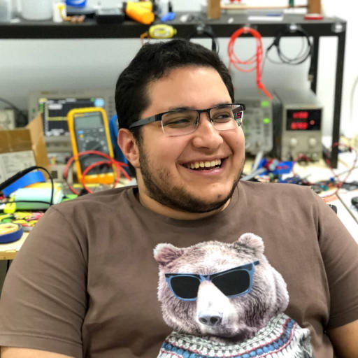 A picture of me smiling with my workbench as the background